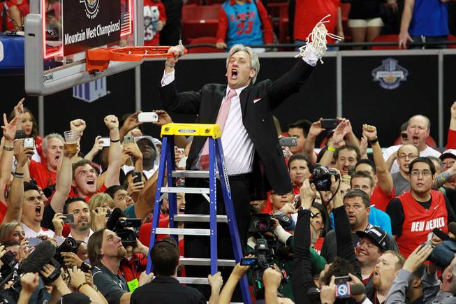New Mexico head coach Craig Neal cuts down the net after the Lobos defeated San Diego State 64-58 in the  Mountain West Conference tournament championship game Saturday, March 15, 2014 at the Thomas & Mack Center. 
