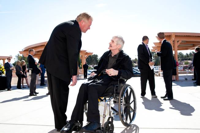 Mike Nolan, left, greets former Raiders Super Bowl champion and quarterback David Humm, a long-time friend of Jackie Gaughan, during the memorial mass for John Davis "Jackie" Gaughan held at St. Viator Catholic Church in Las Vegas on St. Patrick's Day, March 17, 2014.