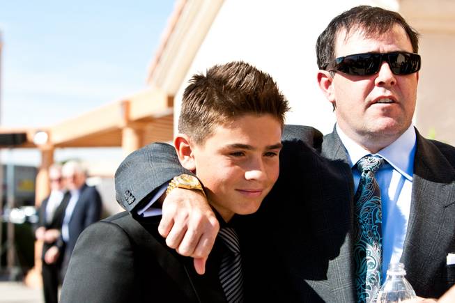 Grandsons Brendan and John Gaughan, left, share an embrace will attending the memorial mass for their grandfather, John Davis "Jackie" Gaughan, held at St. Viator Catholic Church in Las Vegas on St. Patrick's Day, March 17, 2014.