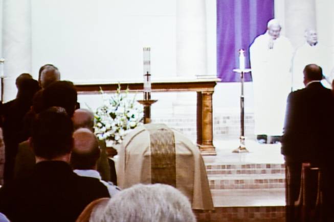 As seen on an overflow video monitor, the casket of John Davis "Jackie" Gaughan lies in wait during the memorial mass at St. Viator Catholic Church in Las Vegas on St. Patrick's Day, March 17, 2014.  Jackie Gaughan, 93, passed away March 12, 2014.