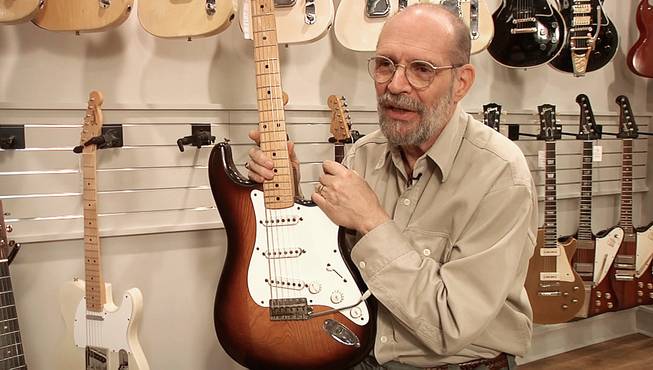 George Gruhn poses with the first production model Fender Stratocaster guitar, Tuesday, March 18, 2014, in Nashville, Tenn. The sunburst-finish Strat bears the serial number 0100. Although some Strats have lower numbers that begin with 0001, Gruhn says they actually were manufactured later in that first year of production.