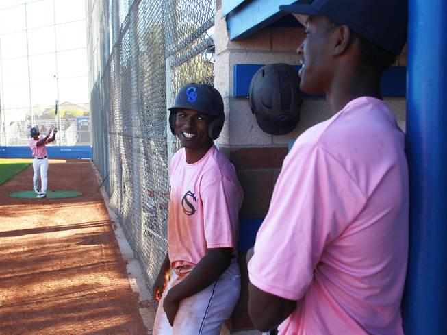 Canyon Springs players Isiah Carter and Rashaad Jones talk during their game against Western Wednesday, March 19, 2014. The Pioneers wore pink jerseys for the game for cancer awareness and to honor parents of two of the players who died from cancer in the past year.