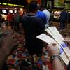 Bettors stand in line to make their wagers at the LVH sports book during the second round of the NCAA basketball tournament Thursday, March 20, 2014.