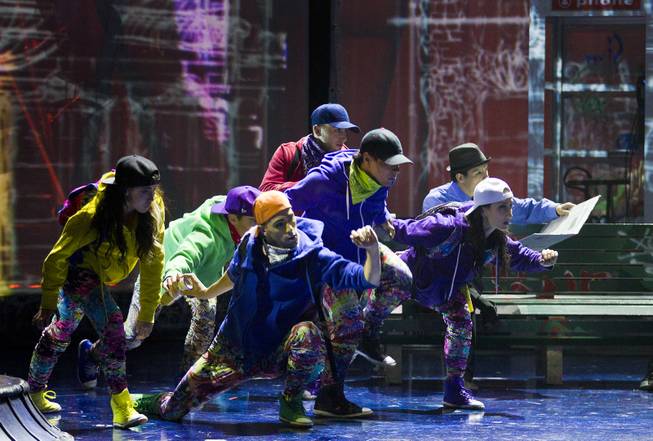 Dancers move across the stage during the One Night for ONE DROP dress rehearsal in the Michael Jackson ONE Theatre on Thursday, March 20, 2014.