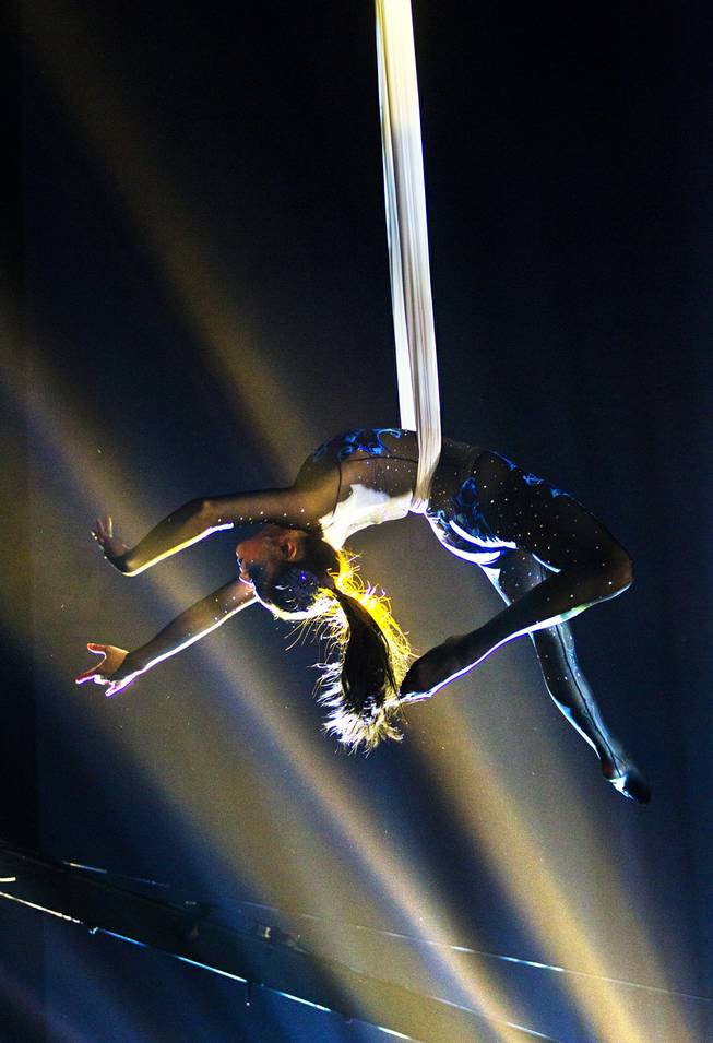 One of many aerialists performs during the One Night for ONE DROP dress rehearsal in the Michael Jackson ONE Theatre on Thursday, March 20, 2014.