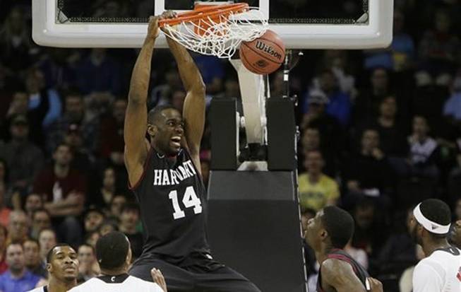 Harvard’s Steve Moundou-Missi (14) dunks against Cincinnati in the second half during the second-round of the NCAA men's college basketball tournament in Spokane, Wash., on Thursday, March 20, 2014.