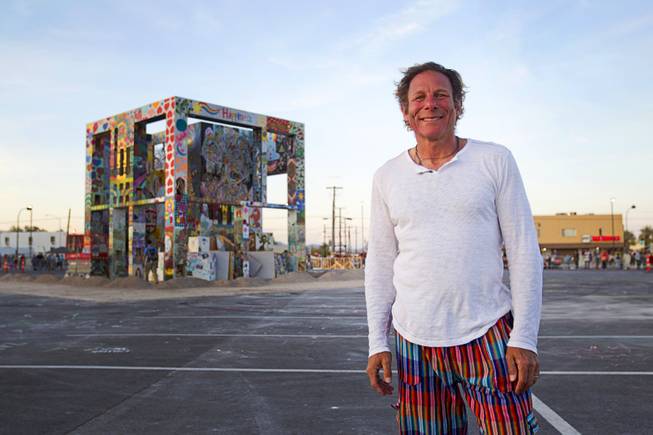 Artist Scott Cohen poses in front of his Life Cube, an interactive community art installation, in downtown Las Vegas, Friday March 21, 2014. The Life Cube, later burned, was a 24-by-24-foot plywood cube, painted by artists and filled with notes from thousands of people.