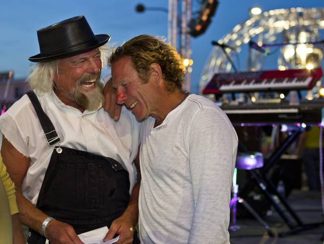 Flash Hopkins shares a laugh with artist Scott Cohen at the Life Cube celebration before the burn in downtown Las Vegas, Friday March 21, 2014. The Life Cube, later burned, was a 24-by-24-foot plywood cube, painted by artists and filled with notes from thousands of people.