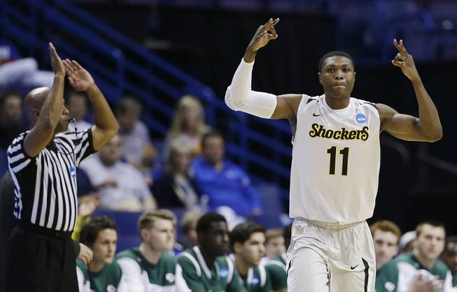 Wichita State forward Cleanthony Early (11) celebrates his three-point basket against Cal Poly during the first half of a second-round game in the NCAA college basketball tournament Friday, March 21, 2014, in St. Louis. 