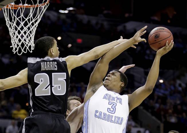 North Carolina's Kennedy Meeks (3) shoots as Providence's Tyler Harris (25) defends during the first half of a second-round game in the NCAA college basketball tournament Friday, March 21, 2014, in San Antonio. 