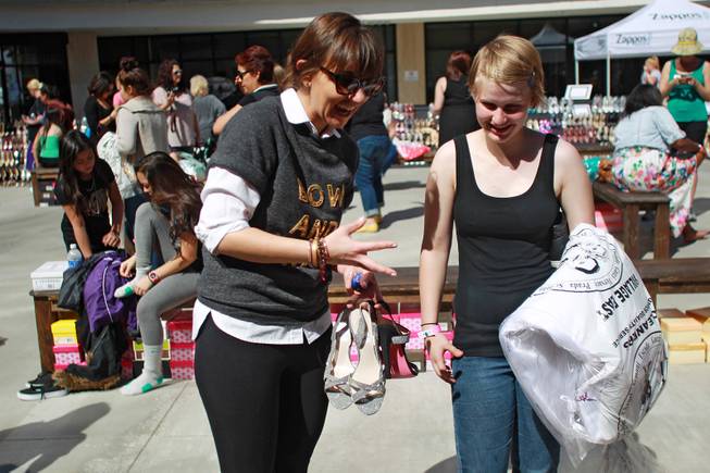 Aubrie Pagano helps Felicia Conley find a pair of shoes during Las Vegas Prom Closet's "Operation Glass Slipper" Saturday, March 22, 2014.
