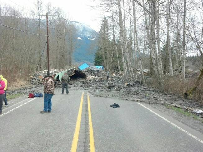 The Washington Department of Transportation says mud, trees and building materials are blocking both directions of State Route 530 near the town of Oso after a mudslide in Snohomish County on Saturday, March 22, 2014. 
