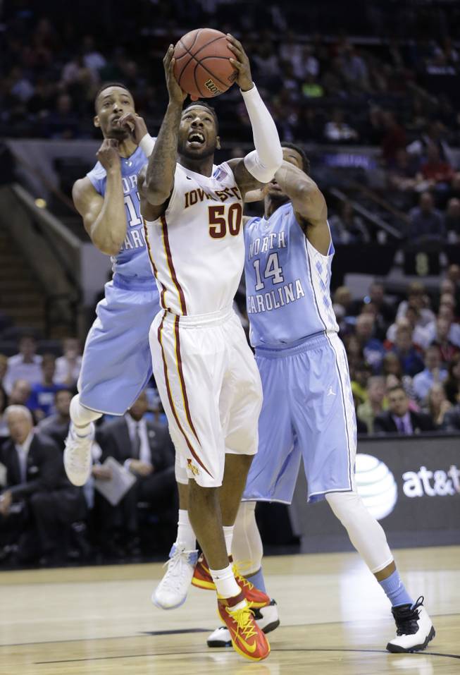 Iowa State's DeAndre Kane (50) is defended by North Carolina's J.P. Tokoto, left, and Desmond Hubert (14) during the first half of a third-round game in the NCAA college basketball tournament Sunday, March 23, 2014, in San Antonio.