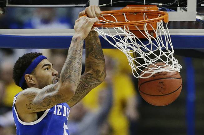 Kentucky forward Willie Cauley-Stein (15) dunks against Wichita State during the second half of a third-round game of the NCAA college basketball tournament Sunday, March 23, 2014, in St. Louis.