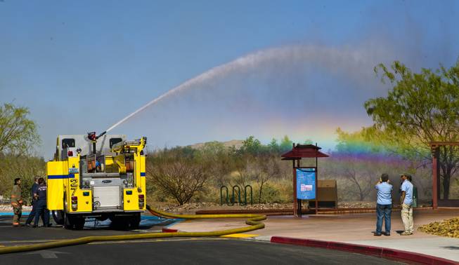 The Clark County Fire Department soaks the land about the Clark County Wetlands Park while battling a four-acre fire north of Sam Boyd Stadium on Monday, March 24, 2014. 