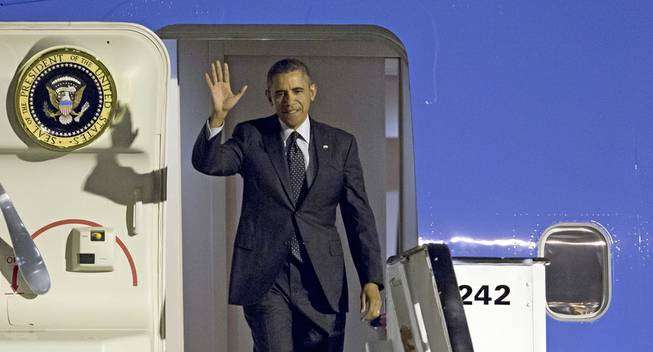 President Barack Obama waves as arrives from Air Force One at Zaventem airport in Brussels on Tuesday, March 25, 2014. Obama is on a one-day visit to Belgium to meet with EU leaders and visit the WWI Flanders Fields American Cemetery. 