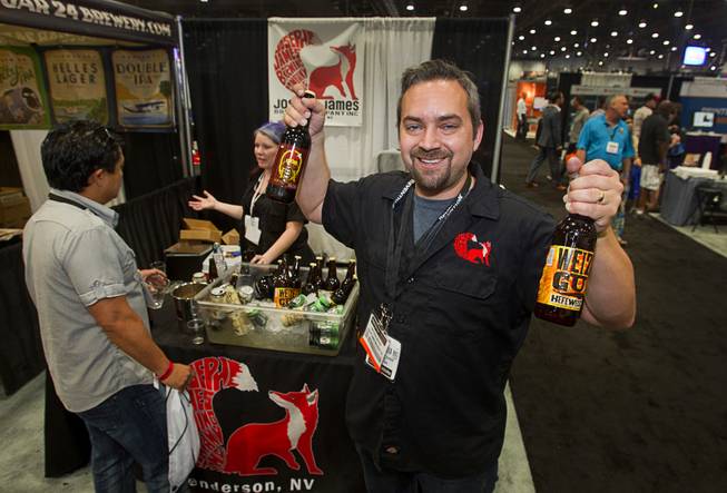 Matthew Marino of Henderson's Joseph James Brewing Company holds up craft beers during the Nightclub & Bar Convention and Trade Show at the Las Vegas Convention Center Wednesday March 26, 2014.