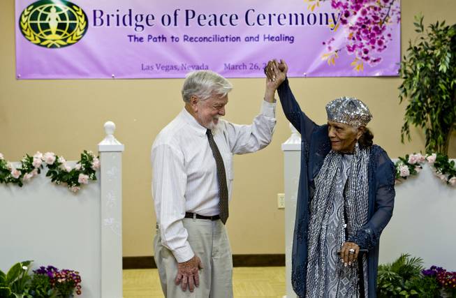 Assemblyman Joseph Hogan and Dr. Sarann Knight Preddy celebrate as they participate in a Bridge of Peace Ceremony of Reconciliation and Healing at the Elks Lodge on Wednesday, March 26, 2014. It was a highlight during A Moulin Rouge Affair sponsored by the Harrison House.