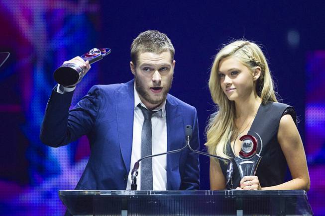 Jack Reynor (L) and Nicola Peltz, Rising Stars of 2014, accept their awards at the Big Screen Achievement Awards during CinemaCon, the official convention of the National Association of Theatre Owners, at Caesars Palace Thursday, March 27, 2014.