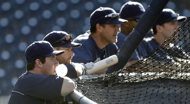 San Diego Padres' Jedd Gyorko blows a bubble as he and teammates line the back of the hitting cage prior to a baseball game between the Padres and Arizona Diamondbacks Tuesday, Sept. 24, 2013, in San Diego.