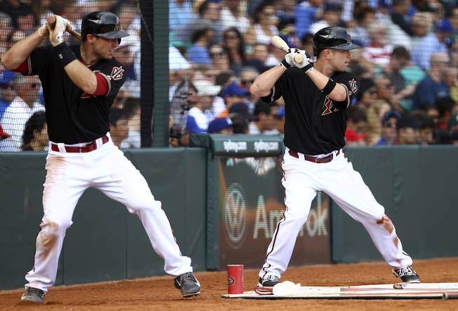 Arizona Diamondbacks' Paul Goldschmidt, left, and Aaron Hill prepare to hit during the second game of the two-game Major League Baseball opening series between the Los Angeles Dodgers and Arizona Diamondbacks at the Sydney Cricket ground in Sydney, Sunday, March 23, 2014. The Dodgers won the game 7-5 and the series 2-0.