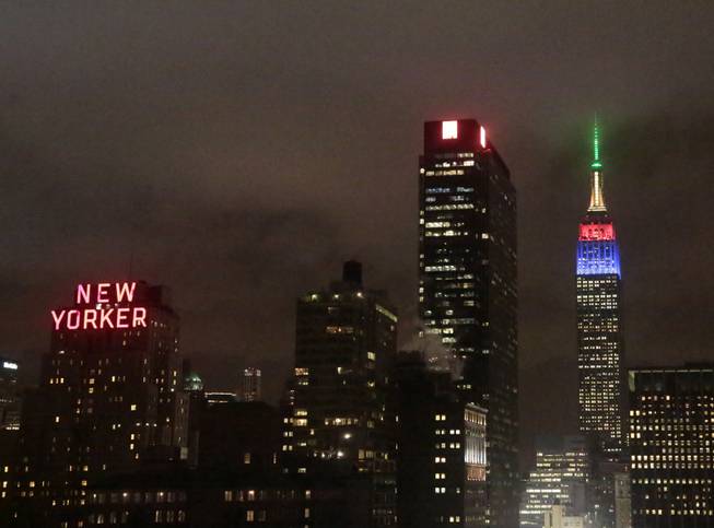 The Empire State Building, right, rises into the climbs into the New York City skyline lit in the colors of the South African Flag to observe the passing of former South African President and Civil Rights leader Nelson Mandela, Friday, Dec. 6, 2103 in New York. Mandela died on Thursday, Dec. 5, 2013 at age 95. 