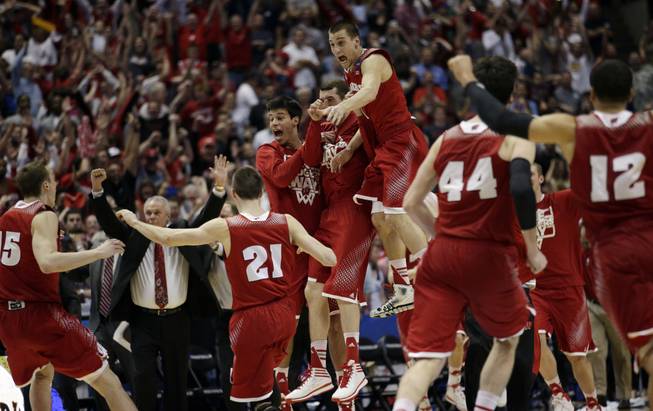 Wisconsin players react as time runs out in overtime in a regional final NCAA college basketball tournament game, Saturday, March 29, 2014, in Anaheim, Calif. Wisconsin won 64-63 in overtime.