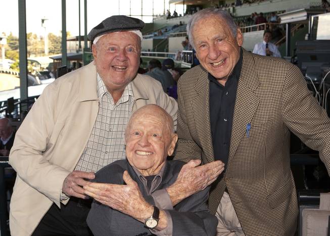 In this Sunday, March 30, 2014, file photo, entertainment icons Dick Van Patten, left, and Mel Brooks flank Mickey Rooney at Santa Anita Park, in Arcadia Calif. Rooney, a Hollywood legend whose career spanned more than 80 years, has died. He was 93. Los Angeles Police Commander Andrew Smith said that Rooney was with his family when he died Sunday, April 6, 2014, at his North Hollywood home.