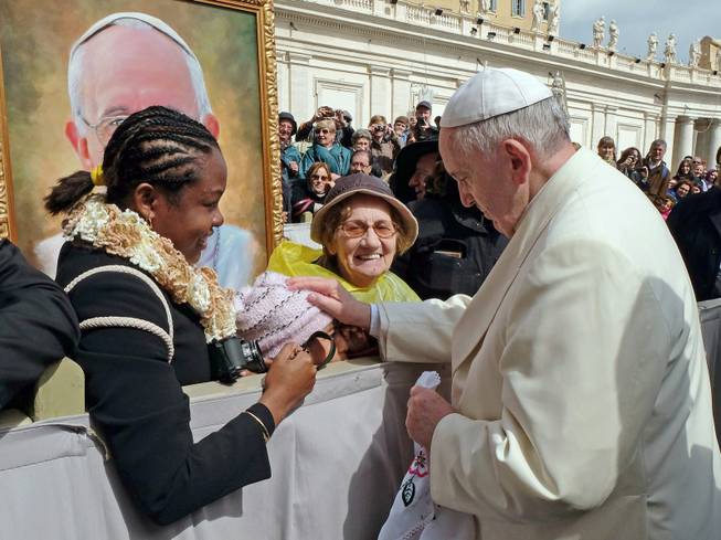 In this photo provided by Catholic Coalition of Immigrant Rights, Pope Francis touches 10-year-old Jersey Vargas, who traveled to the Vatican from Los Angeles to plead with him to help spare her father from deportation, during a public audience at St. Peter's Square in Vatican City. Her father, Mario Vargas, in the United States illegally, had been in federal custody and faced possible deportation. After speaking with Francis, Mario Vargas was released on bond from immigration detention, Immigration and Customs Enforcement said Friday, March 28, 2014. Jersey Vargas was part of a California delegation that sought to encourage the Vatican to prod President Obama on immigration reform. 