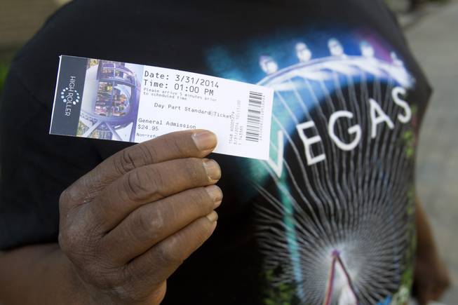 Entertainer Larry Edwards displays a ticket for the first public ride on the 550-foot-tall High Roller observation wheel Monday, March 31, 2014. The observation wheel, the tallest in the world, is part of the Linq project, a $550 million development by Caesars Entertainment Corp.