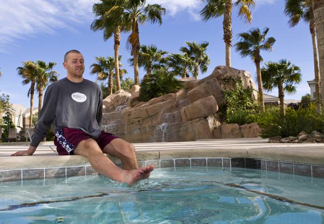 Brendan Remple with the Las Vegas Wranglers Professional Hockey Club soaks his sore legs in the hot tub at his condo complex on Tuesday, April 1, 2014.