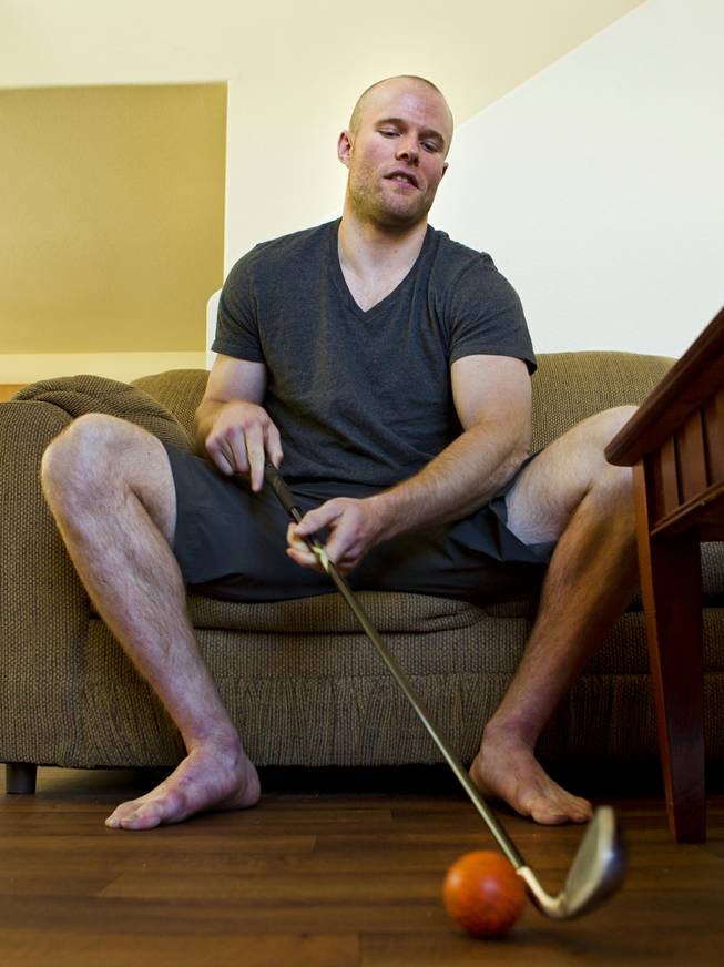 Geoff Irwin with the Las Vegas Wranglers Professional Hockey Club likes to stay sharp at home by tapping a ball around while watching hockey on television Tuesday, April 1, 2014.