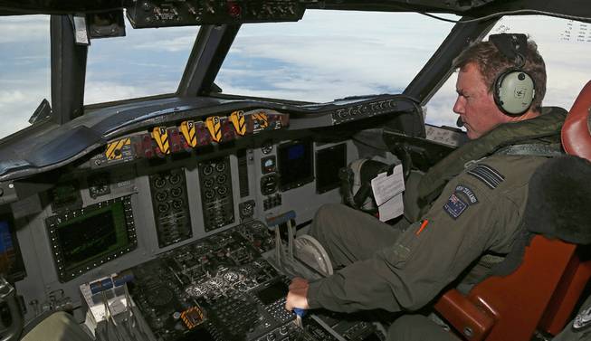 A Royal New Zealand Air Force P-3 Orion's co-pilot and Squadron Leader Brett McKenzie controls the pane while searching for the missing Malaysia Airlines Flight MH370 in the southern Indian Ocean, Monday, March 31, 2014. 