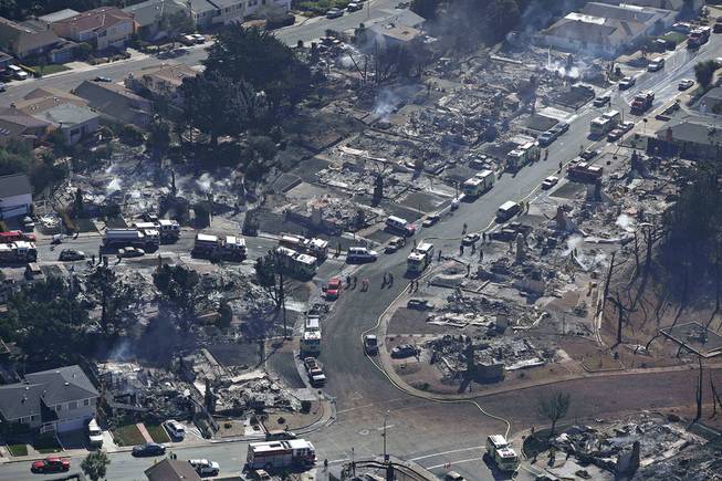 Firefighters and rescue crews work among damage caused by a pipeline explosion and an ensuing massive fire in a residential neighborhood in San Bruno, Calif., Sept.10, 2010.