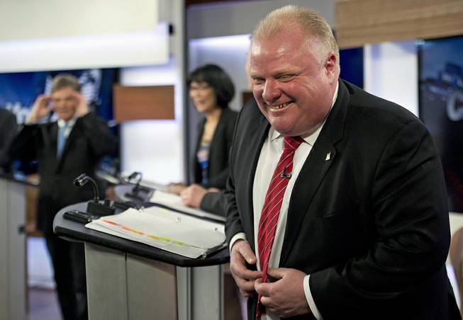 Mayor Rob Ford laughs during a commercial break as he takes part in a live television mayoral debate in Toronto on Wednesday, March 26, 2014. 