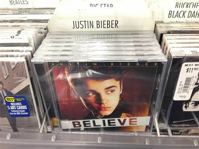 A CD that appears to be Justin Bieber's "Believe" sits on the rack at the Best Buy in Culver City, Calif., Tuesday April 1, 2014. Paz, a 25-year-old electronic musician and artist, says he's planted 5,000 copies of an album that appears to be Bieber's "Believe" but that actually contains a copy of his own CD in retailers such as Best Buy, Walmart and Target on April Fool's Day. This album turned out to be a copy of Paz's  CD.