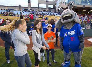 Las Vegas 51's mascot Cosmo jokes with Macy Perkes, 11, Emma Perez, 11, and Kate Perkes, 9 before the 51's season opener against the Fresno Grizzlies Thursday, April 3, 2014.