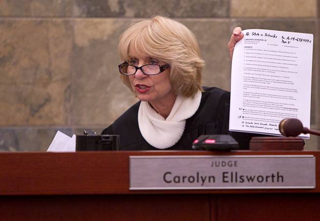 Judge Carolyn Ellsworth holds up documents during a hearing for John Michael Schaefer, a candidate for Nevada state controller, at the Regional Justice Center Thursday, April 3, 2014. Election officials want the court to remove Schaefer from the Democratic primary ballot because they contend he doesn't meet residency requirements.