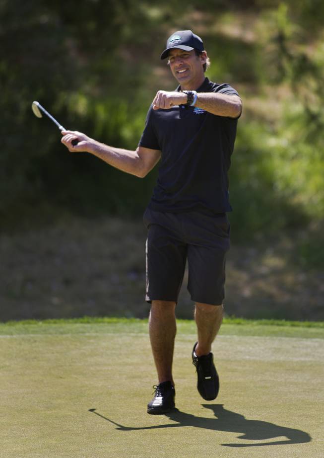 Former NHL player Chris Chelios reacts to a near miss during opening day play of the Michael Jordan Celebrity Invitational at Shadow Creek Golf Course on Thursday, April 3, 2014.