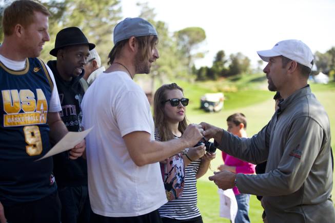 Former MLB player John Smoltz signs autographs for fans during opening day play of the Michael Jordan Celebrity Invitational at Shadow Creek Golf Course on Thursday, April 3, 2014.