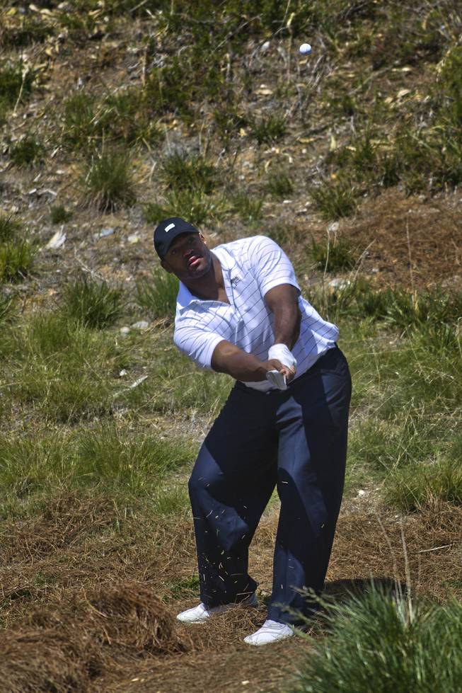 Dwight Freeney of the San Diego Chargers chips the ball from the rough during opening day play of the Michael Jordan Celebrity Invitational at Shadow Creek Golf Course on Thursday, April 3, 2014.