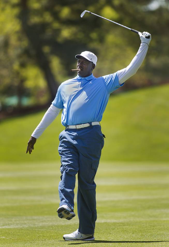 Former NBA star Michael Jordan reacts to a shot during opening day play of the Michael Jordan Celebrity Invitational at Shadow Creek Golf Course on Thursday, April 3, 2014.