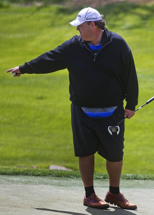 Actor Brian Baumgartner helps his teammates read the green on the opening day of the Michael Jordan Celebrity Invitational at Shadow Creek Golf Course on Thursday, April 3, 2014.