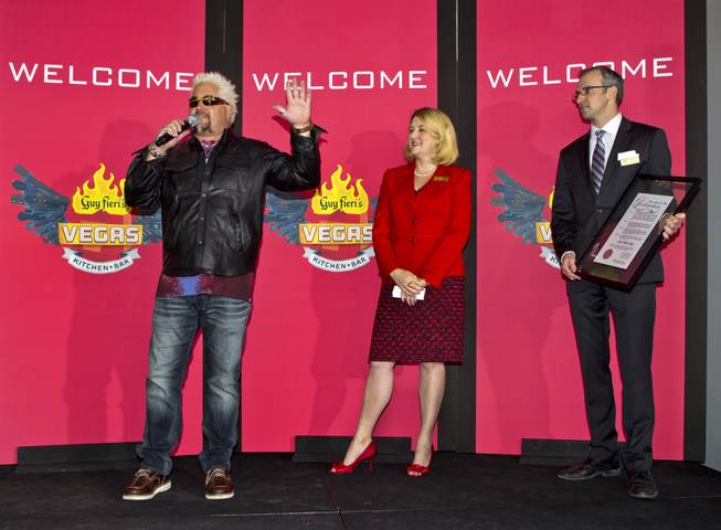 Guy Fieri thanks his fans at The Quad as he arrives to introduce his first Las Vegas restaurant Guy Fieri's Vegas Kitchen & Bar on Friday, April 4, 2014.  He is joined on stage by Eileen Moore, Caesar's regional president and general manager, with Christian Stuart, regional vice president and assistant general manager.