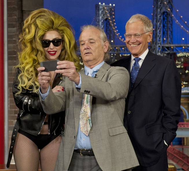 Bill Murray, center, takes a selfie with Lady Gaga and David Letterman during "The Late Show With David Letterman" on Wednesday, April 2, 2014, in New York. The singer had Murray, Letterman and the entire audience over to the Roseland Ballroom for her performance.