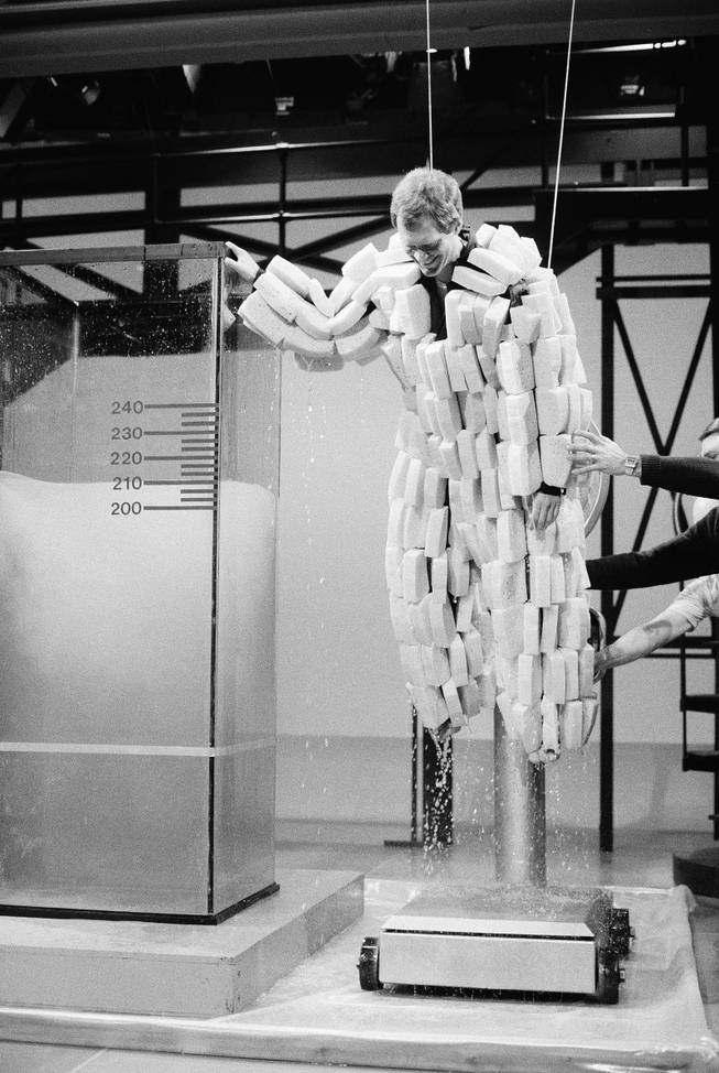 David Letterman, host of NBC-TV's "Late Night with David Letterman, " is taken from a tank of water and placed onto a scale in New York while wearing a specially designed suit of sponges, Feb. 14, 1985. Letterman weighed 190 lbs. before and a whopping 500 lbs. after soaking up about 25 gallons of water, during taping for Thursday night's show. 