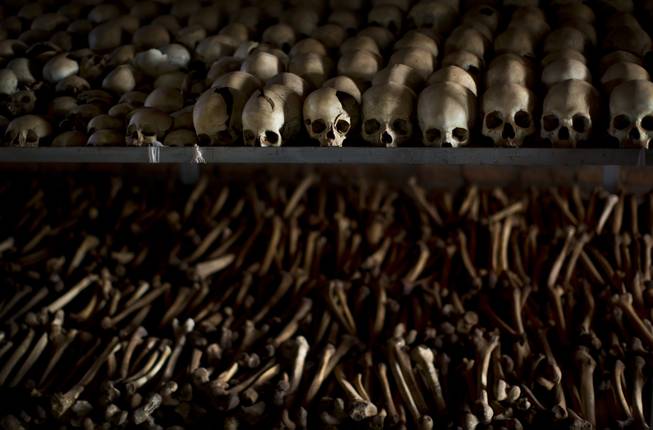 The skulls and bones of some of those who were slaughtered as they sought refuge inside the church are laid out as a memorial to the thousands who were killed in and around the Catholic church during the 1994 genocide in Ntarama, Rwanda, Friday, April 4, 2014.