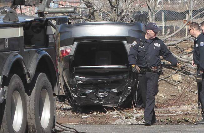 Police recover a 2009 Honda Accord that tumbled into Steinway Creek on Saturday, April 5, 2014, in New York. The driver of the car drove off a dead-end street in a desolate industrial area, flipped over a wooden curb into the East River inlet, killing four passengers.