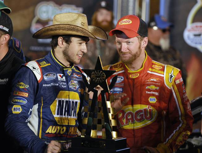 Chase Elliott, left, talks with team owner Dale Earnhardt Jr. in Victory Lane after Elliot won the NASCAR Nationwide Series auto race at Texas Motor Speedway in Fort Worth, Texas, on Friday, April 4, 2014.