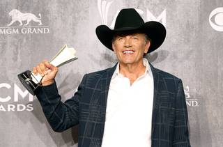 George Strait, winner of the Entertainer of the Year award, poses in the photo room during the 49th Academy of Country Music Awards at the MGM Grand Garden Arena Sunday, April 6, 2014.